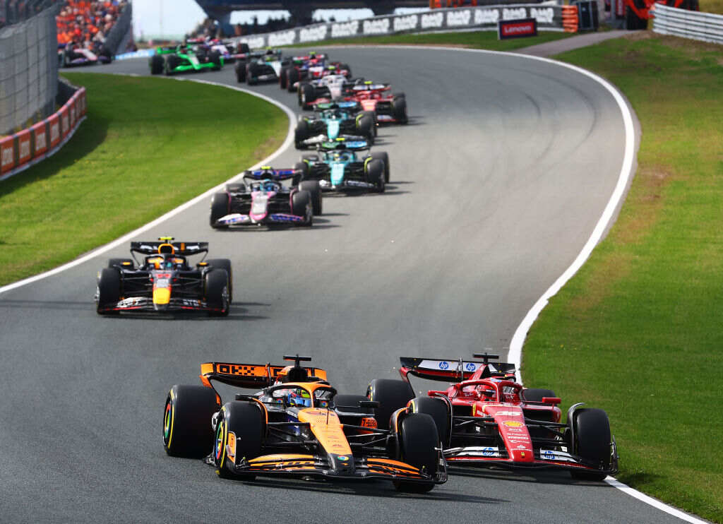 Aerial view of a Formula One track showing cars lined up on the starting grid before qualifying ends