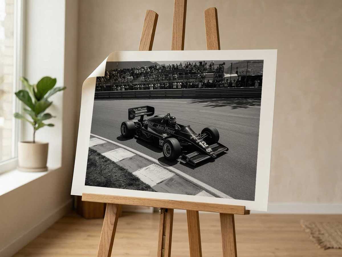 Low-angle shot of the Lotus F1 car emphasizing towering silhouette and aggressive stance