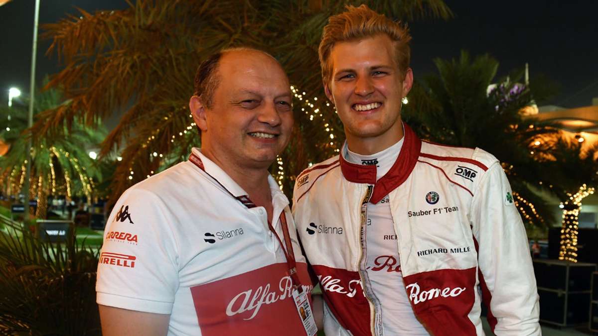 Marcus Ericsson steering into a high-speed corner, front wheels sharply turned and body leaning, showing precise wheel…