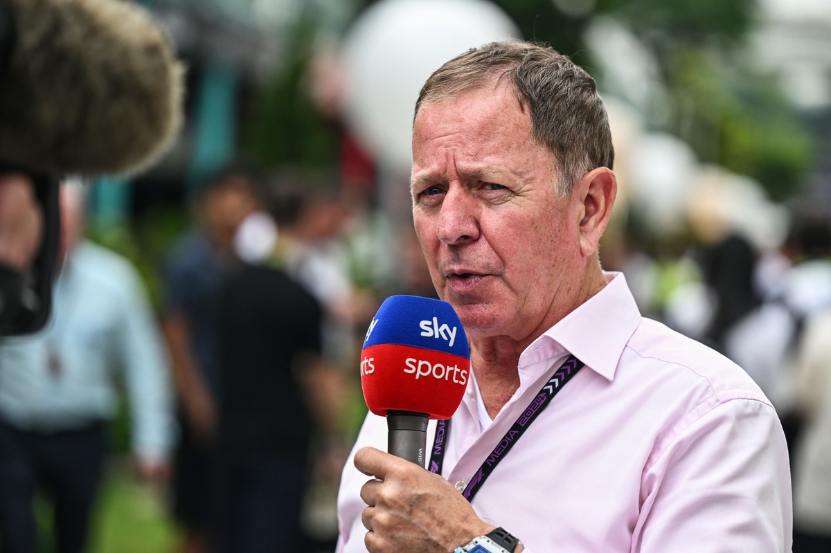 Martin Brundle's Formula 1 car overturned after an early career crash, showing damaged front wing and marshals at the scene