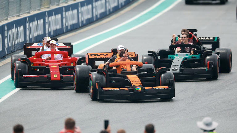 Formula One car flat out on a long Miami straight with blurred grandstands, highlighting precision at high speed