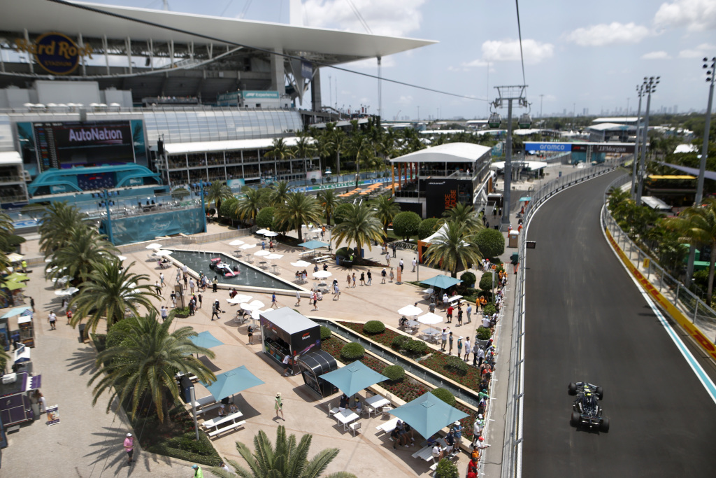 Modern F1 car flat out on Miami long straight showing rear wing and airflow balance