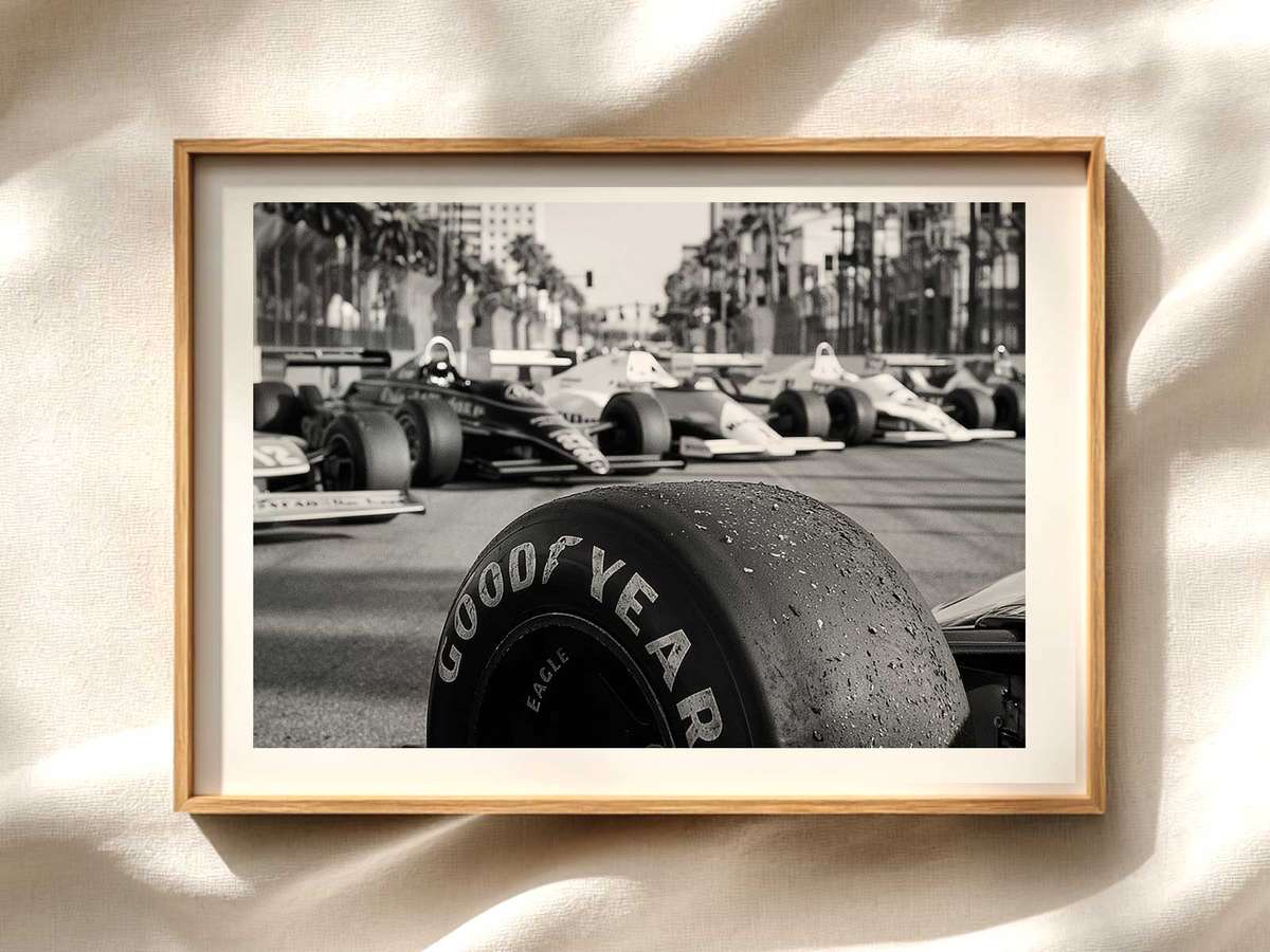F1 cars squeezed between towering urban facades on the Miami International Autodrome, showing compressed perspective and…