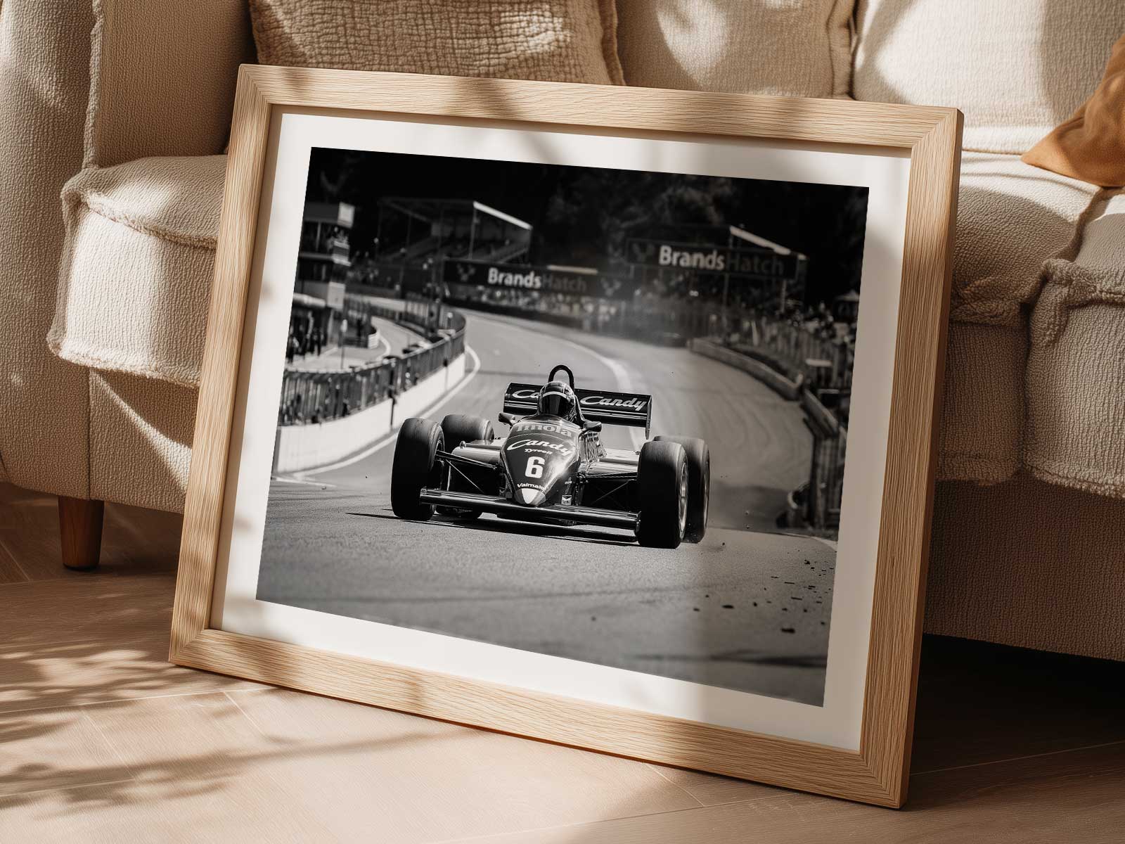 Driver hunched in the Tyrrell cockpit, visor reflecting the track, expression focused and intense under dramatic lighting