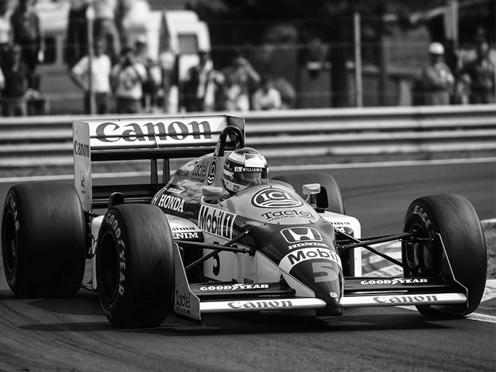 Williams FW11 captured in side profile with 1980s film grain and faded colors emphasizing its aerodynamic lines